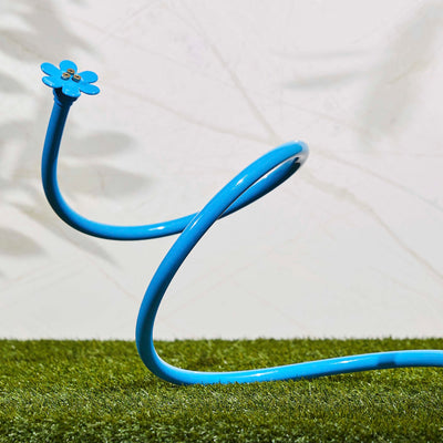 Blue flex cobra personal mist cooling sprayer, displayed on grass. 